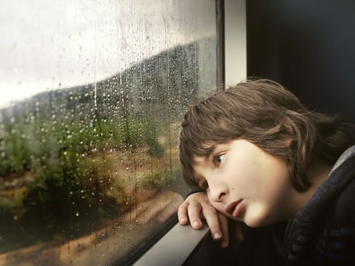 Jongen kijkt uit het raam